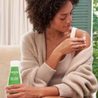 Weleda Body Lotion woman holding bottle